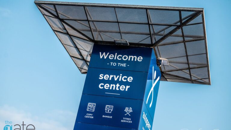 Welcome sign for a service center at a business complex.